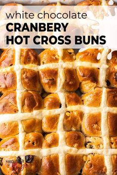 white chocolate cranberry hot cross buns on a baking sheet with text overlay