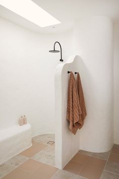 two towels hanging on the wall in a bathroom