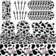 black and white cow print tableware set with forks, spoons, napkins and utensils