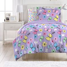 a purple bed with colorful butterflies on it