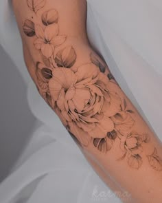 a woman's arm with flowers on it