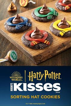 harry potter cookies are on a wooden board with the words, harry potter kisses sorting hat cookies