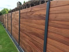 a wooden fence with metal posts on the side