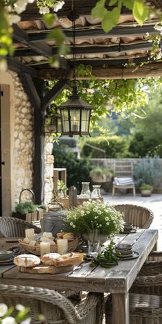 an outdoor dining area with table and chairs