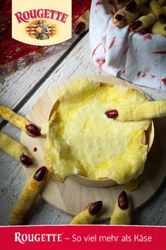 there is a pie on the table with cranberries and breadsticks around it