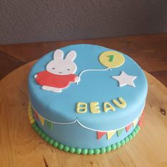 a birthday cake for a one year old on a wooden table