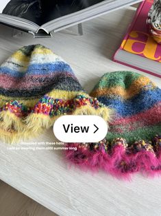 a colorful hat sitting on top of a table next to a book