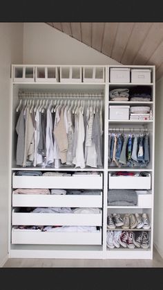 a white closet filled with lots of clothes