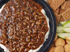 an image of food on the table with crackers and apple slices in the background