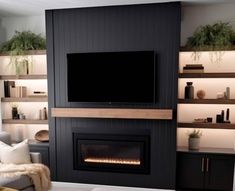 a living room filled with furniture and a flat screen tv mounted on the wall above a fireplace