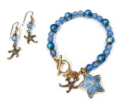 Blue and Gold Starfish Bracelet and Earring Set, Blue Starfish Sea Glass Jewelry, Starfish Bracelet, Beach Lover Gift, Beach Gifts For Women______________________________________________________You're gonna love this stylish blue and gold starfish bracelet and earring set!  It's  made with a gorgeous enamel starfish charm on the bracelet, and delicate antique gold filigree starfish accent charms too!  Get the starfish bracelet, or just get the starfish earrings--your choice.  Everyone loves blue Starfish Bracelet, Beach Lover Gifts, Starfish Earrings, Beach Gifts, Blue Sea Glass, Gold Filigree, Metallic Blue, Sea Glass Jewelry, Starfish