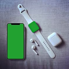 an apple watch, ear buds and green screen protector on a gray surface with white accessories