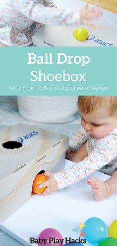 a baby playing with a ball drop shoebox