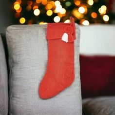 a red christmas stocking sitting on top of a couch