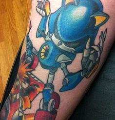 a person with a tattoo on their leg that has an image of sonic the hedgehog