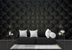 a black and white living room with two couches, pillows and vases on the floor