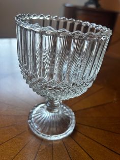 a glass bowl sitting on top of a wooden table