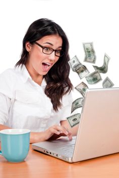 a woman sitting in front of a laptop computer with money coming out of it