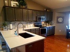 a kitchen with wooden floors and stainless steel appliances