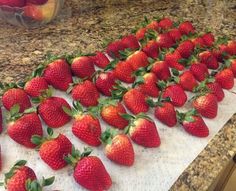 a bunch of strawberries on a counter top