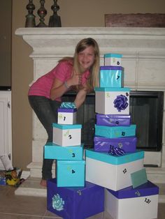 a woman is leaning on some boxes in front of a fire place with her hand on the top