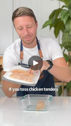 a man in an apron is making chicken tenders