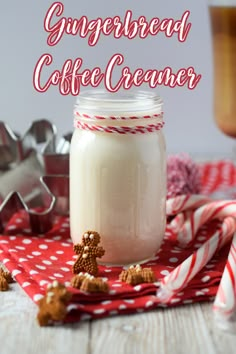 a glass jar filled with gingerbread coffee creamer next to candy canes and cookies