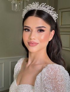 a woman wearing a tiara and posing for the camera