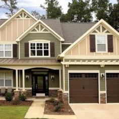 a large house with two garages on the front and one story home in the back