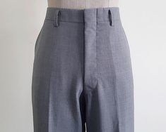 Vintage Gray Straight Leg Pants - Fabric : 60% wool 35% polyester 5% polyurethane - Nylon zipper on the front - Pockets - Unlined - Made in Japan - Very good vintage condition Measurements : Waist : 30" Hips : 40" Front rise : 11" Back rise : 16.5" Inseam : 32" Total length : 42" Width of hem : 19" Our products are vintage clothing that will be cleaned so you can be confident in the quality. We carefully inspect each garment to make sure that you get the most accurate and informed description possible. We do our best to state any imperfections in the listing. If a flaw accidentally escapes our inspection, please let me know as soon as possible and we will be happy to help remedy the situation. Please read the product description carefully before purchasing to ensure it meets your needs. If Fitted Gray Bottoms With Hip Pockets, Fitted Gray Pants With Hip Pockets, Full Length Solid Wool Pants, Full Length Wool Pants, Solid Full-length Wool Pants, Fitted Gray Wool Pants, Fitted High-waisted Work Pants With Hip Pockets, Fitted Wool Pants In Gray, Fitted Wide-leg Dress Pants With Hip Pockets