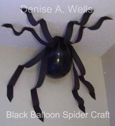 a black spider sculpture hanging from the ceiling