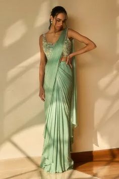 Sea green pre-draped saree with bead embellished borderPaired with floral embellished padded blouse. Component2 PatternEmbellished Type Of WorkFloralbead NecklineV neck Sleeve TypeSleeveless FabricBlouse and SareeViscose Georgette SatinLiningShantoon ColorGreen Other Details Back deep V neck Weight (in gms0.5 OccasionReceptionAza Fashions Draped Lehenga, Arpita Mehta, Ridhi Mehra, Festive Outfits, Draped Saree, Simple Saree Designs, Desi Outfits