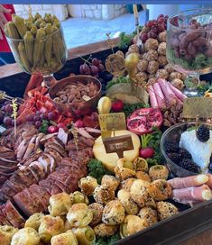 an assortment of meats and cheeses on display in a buffet style food tray