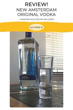 a bottle of vodka and two glasses on a table with the words vodka written below it