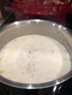 a pot filled with soup sitting on top of a stove