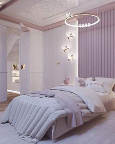 a white bed sitting under a chandelier in a bedroom