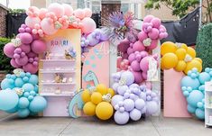 an outdoor birthday party with balloons and decorations