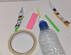 toothbrushes, tape, and water bottle sitting on a table