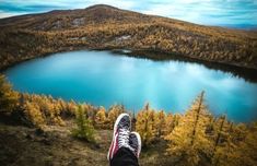 a person standing on top of a hill next to a lake with the words 9 travel inspired instagrams to fuel your wanderlust