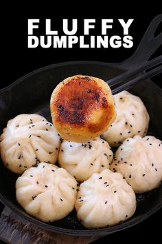 a pan filled with dumplings on top of a wooden table