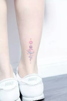 a woman's foot with a tattoo on it