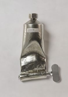 a metal bottle with a corkscrew attached to it