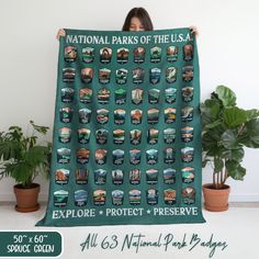 a woman is holding up a poster that says national parks of the usa