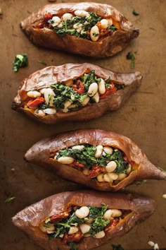 three baked sweet potatoes with white beans and spinach