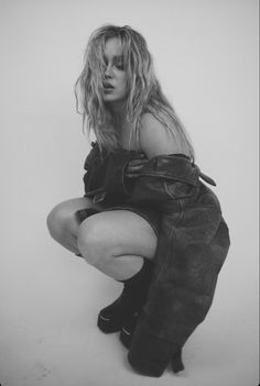 a black and white photo of a woman in boots