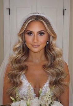 a woman with long blonde hair wearing a wedding dress