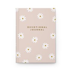 a pink journal with daisies and the words,'devotnal journal '