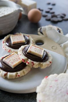 some cookies are on a plate with chocolate and sprinkles