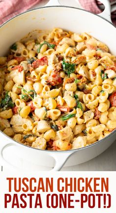 a pan filled with pasta and spinach on top of a table