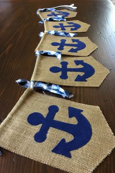 three burlocks with blue and white designs are lined up on a wooden table